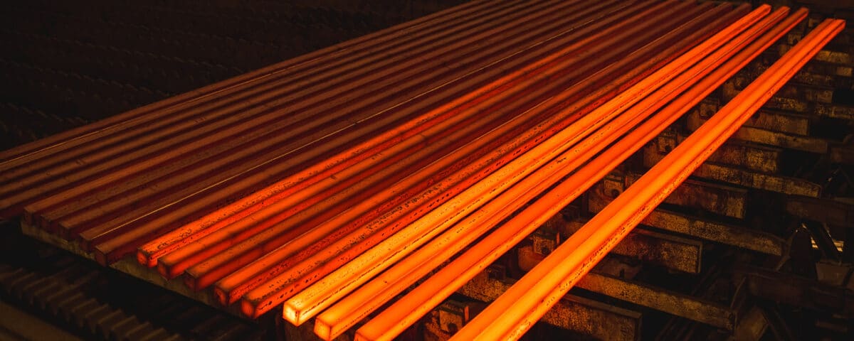 Hot square steel bloom on the roll table.